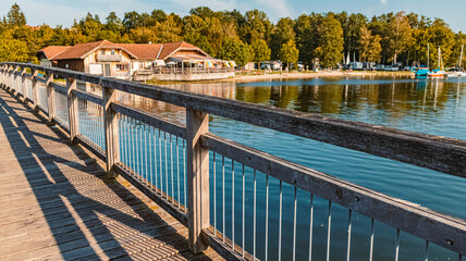 Beautiful autumn or indian summer view with a bridge at the famous Waginger See, Waging, Bavaria,...