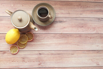 Top view of lemon tea on wooden background.