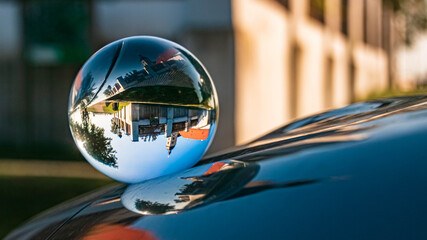 Crystal ball landscape shot with reflections on a car roof at the famous Bogenberg, Danube, Bavaria, Germany