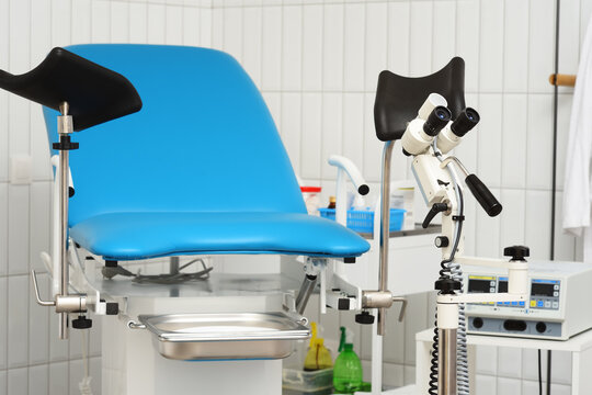blue gynecological chair and colposcope close-up in a modern clinic.