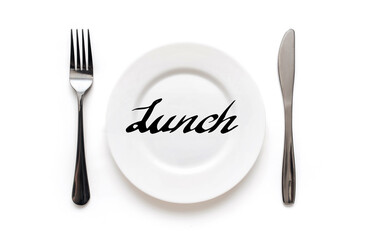 A white plate on which the word Lunch is written standing on a tablecloth . The concept of a balanced diet, ration and medical fasting. Top view, white background, copy space.