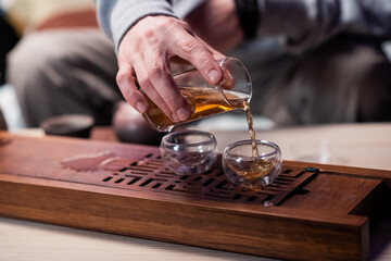 Recipe for creating delicious black tea according to chinese traditions. Close-up set of glass and clay dishes for tea. Flasks and kettle