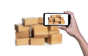 Obraz premium Hand taking photo of cardboard boxes for delivery or moving with smart phone