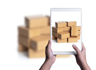 Hand taking photo of cardboard boxes for delivery or moving with tablet