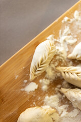 Homemade recipe for ravioli dumplings. Pelmeni-Russian dumplings on a wooden background