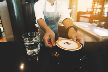 service staff or owner standing in coffee shop