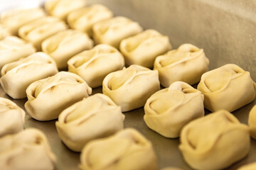 Homemade recipe for ravioli dumplings. Pelmeni-Russian dumplings on a wooden background
