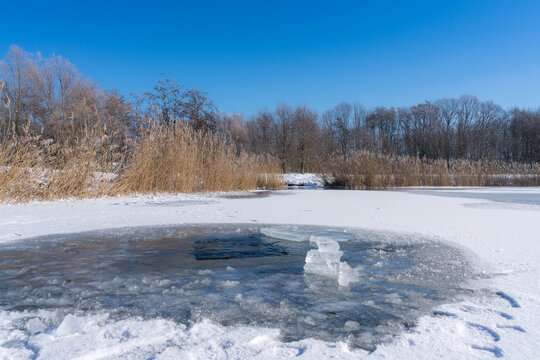 Ice hole for an ice bath in a lake at sunny weather