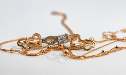 Set of gold jewelry: a chain with a pendant, earrings and a ring with Topaz