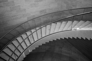 Obraz premium Black and white image of a concrete stairs with metal handlebars