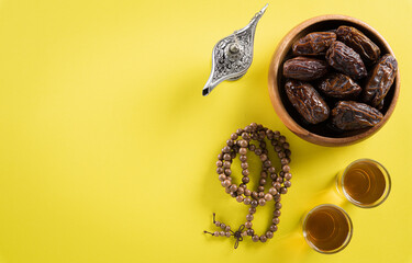 Fototapeta na wymiar Top view image of decoration Ramadan Kareem, dates fruit, aladdin lamp and rosary beads on yellow background. Flat lay with copy space.