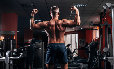 Fototapeta na wymiar Beautiful and muscular man's back in gym