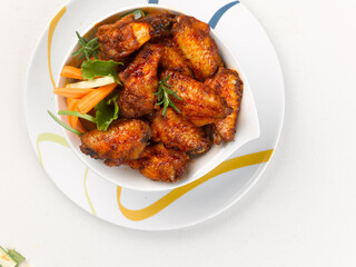 plate of marinated chicken wings, on white background