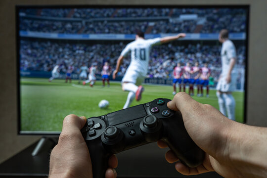 Point of view video gaming. Playing video game on Playstation. FIFA footbal game 