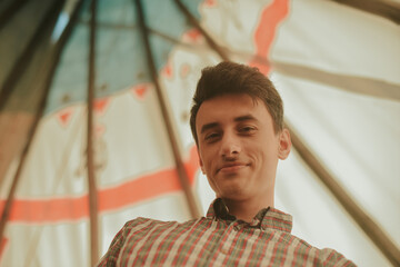 A man lives in a field in a teepee house. The guy travels a lot and enjoys life. An interesting...