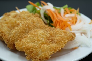 Breaded Fried Fish steak on white plate