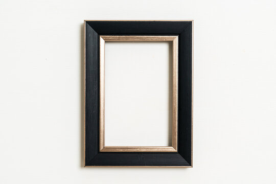 empty picture frame on white wall background