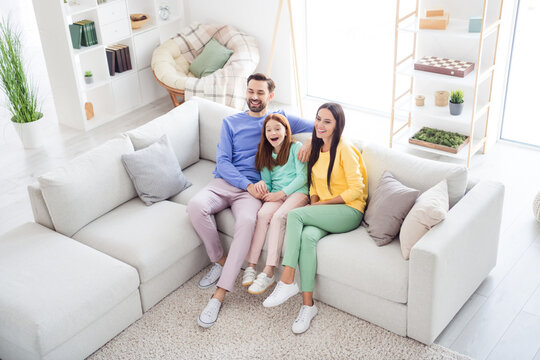 Top above high angle view full body photo of cheerful family happy positive smile sit sofa indoors laugh watch movie