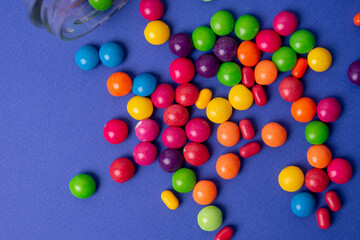 colorful little candies on a colored background