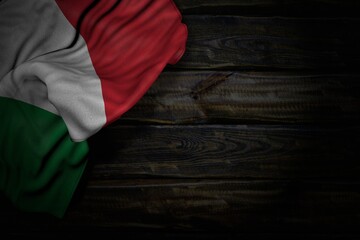 beautiful dark photo of Italy flag with large folds on old wood with empty place for content - any occasion flag 3d illustration..