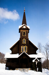 Fototapeta na wymiar Old wooden church in winter, Tatranska Javorina, Poprad District, Slovakia
