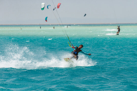 Kitesurfing on the waves of the Red sea, Egipt. Kitesurfing, Kiteboarding action photos Kitesurfer In action