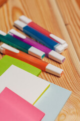 Obraz premium multicolored markers paper office school items wooden table