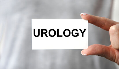 The girl holds a business card in front of her with the text UROLOGY.