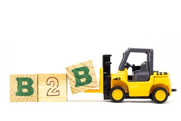 Toy forklift hold letter block b to complete word b2b (abbreviation of business to business) on...