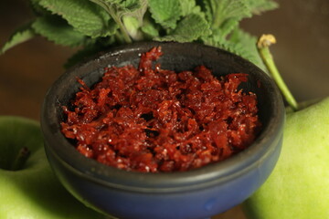 bowl with hookah tobacco. berries on a black background. nargile smoking
