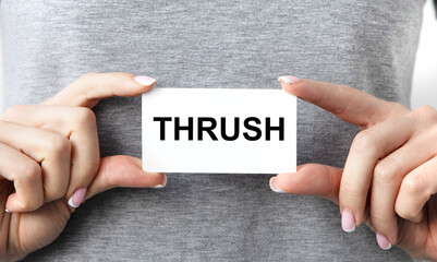 The girl in front of her holds a business card with THRUSH tacts.