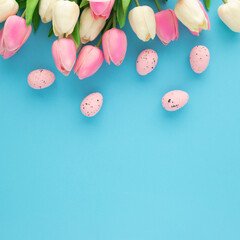 Easter invitation with tulips on a blue background with copy space