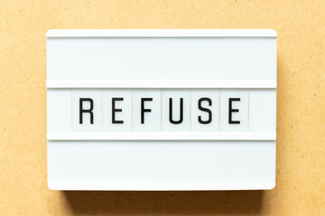 Lightbox with word refuse on wood background