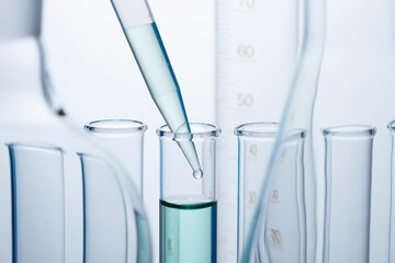 A precision micropipette is used to transfer a small amount of liquid to a test tube. Pipettes are commonly used in chemical and biological laboratory research