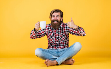 try this. man drink hot tea from cup. good morning. energetic warm beverage. coffee for inspiration. perfect start of the day. happy bearded man drinking morning coffee. thumb up for best taste