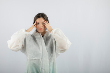 Portrait of young female doctor scientist in defensive lab coat posing