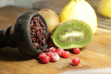 bowl with hookah tobacco. shisha with fruits on black background.