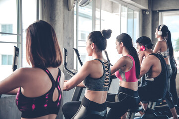 Fototapeta premium People working out at spinning class in the gym.