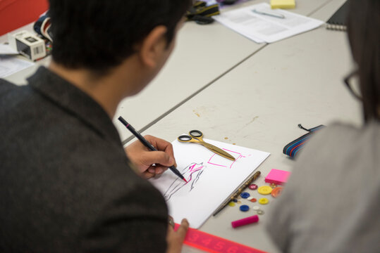 Fashion student sketching design
