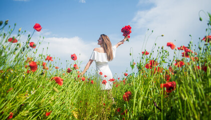 Young beautiful woman in spring walking in amazing poppy field, freedom © be free