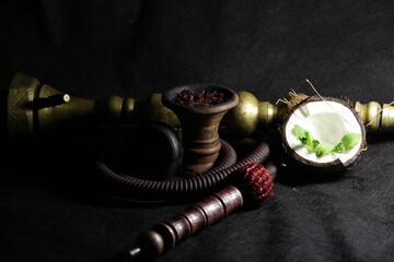 bowl with hookah tobacco. nargile with fruits on a black background. smoking tobacco