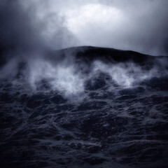 Clouds rolling over a mountain peak in the Scottish Highlands.Dark and dramatic landscape scene with atmospheric mood.