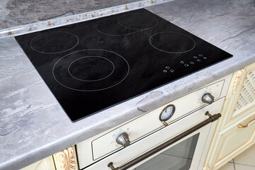Modern kitchen luxurious interior with black induction or electric hob stove cooker with ceramic...