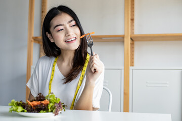 Young woman eating healthy salad in diet concept.