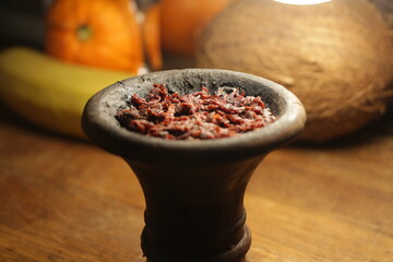 bowl with hookah tobacco. shisha with fruits on black background.