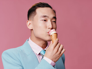 Man eating ice cream lifestyle pink background close-up