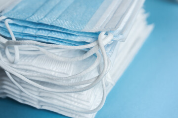 stack of surgical face masks,background white and blue