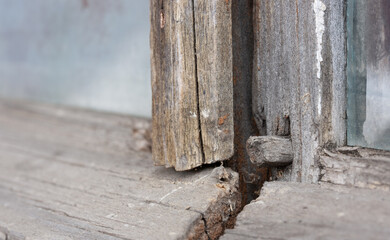 Old wooden window frame with a wooden nail sticking out