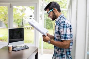 Caucasian man reading business news.