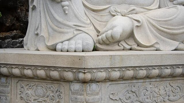 Buddhist fairy Maitreya stone statue close-up
